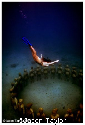 Donna diving into a new sculpture installation in Grenada. by Jason Taylor 